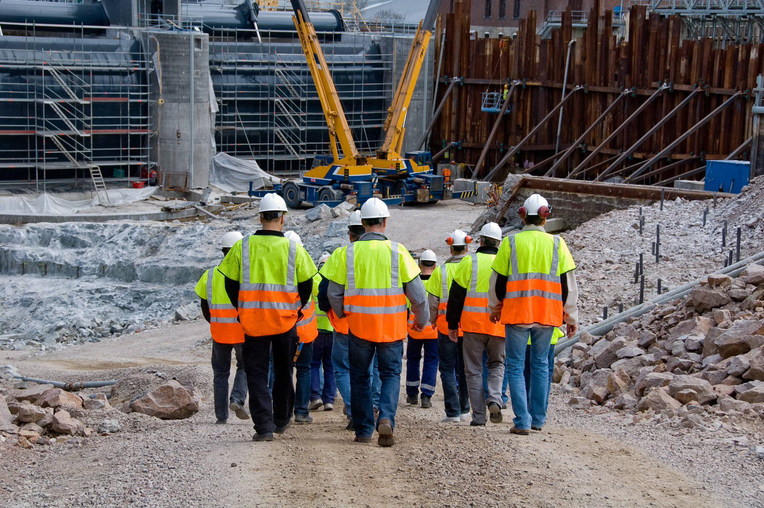 Construction workers walking a construction site.