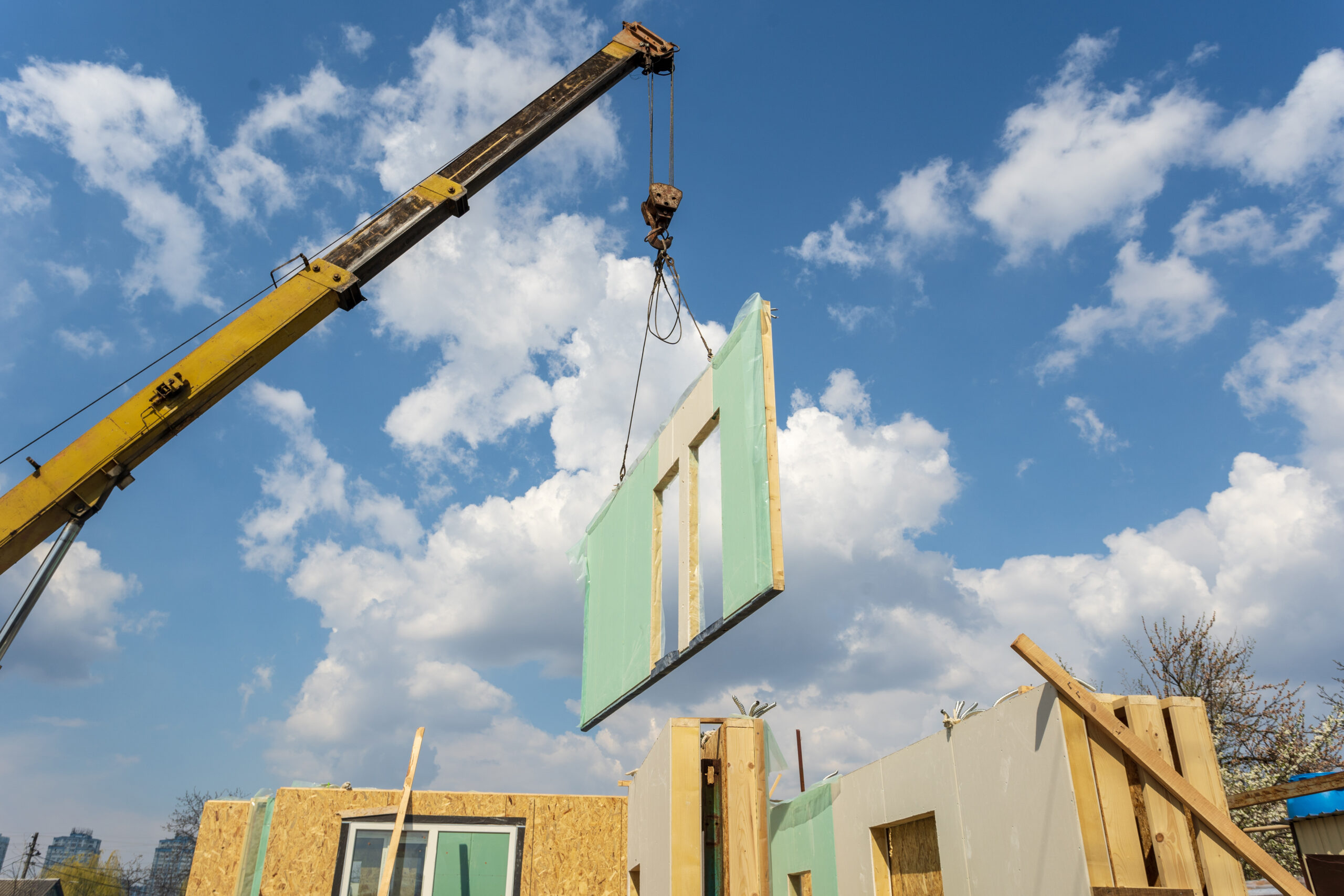 Crane with wall part against blue sky background