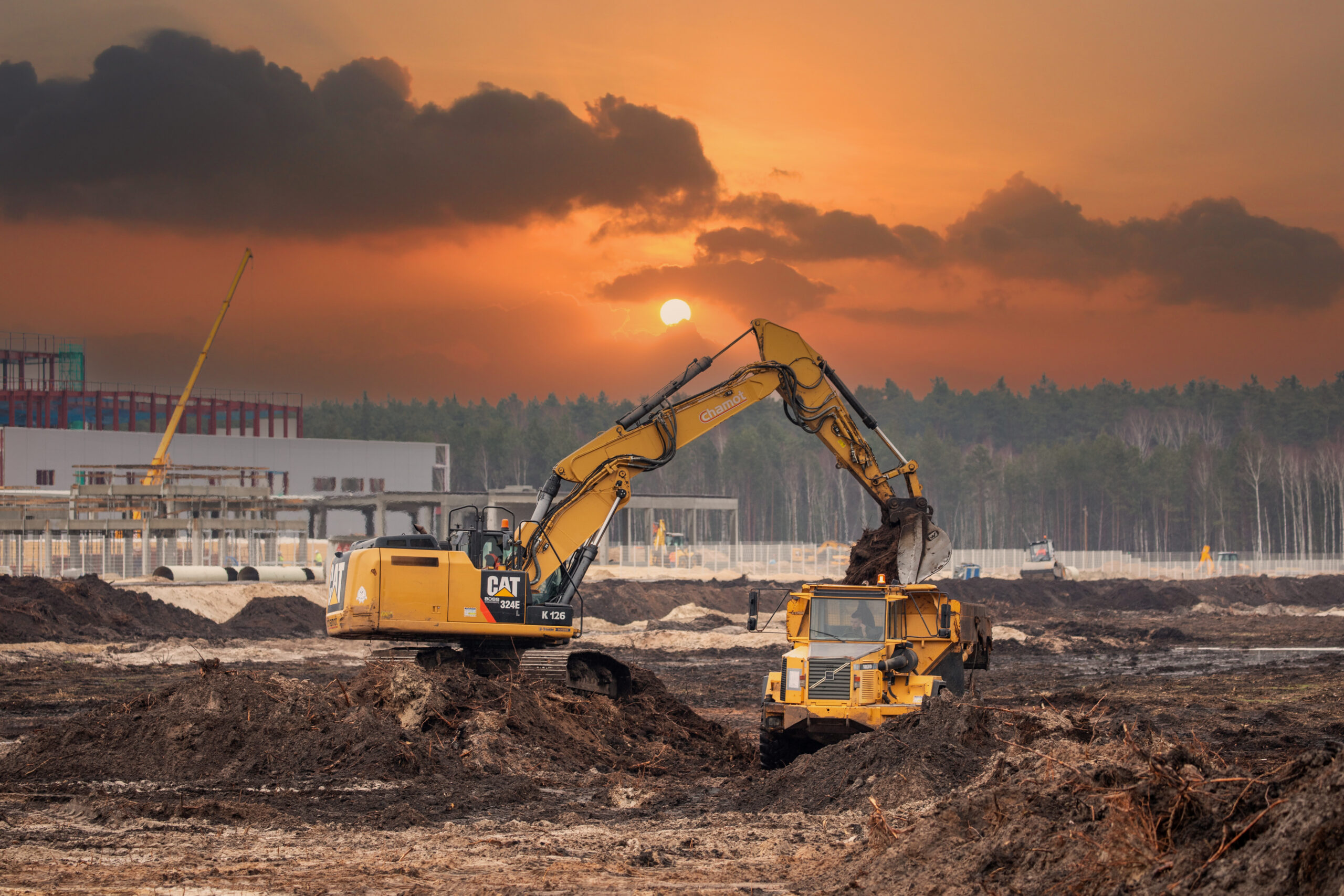 Dump trucks and excavator on a construction site. Construction equipment. Heavy machines. Construction site.