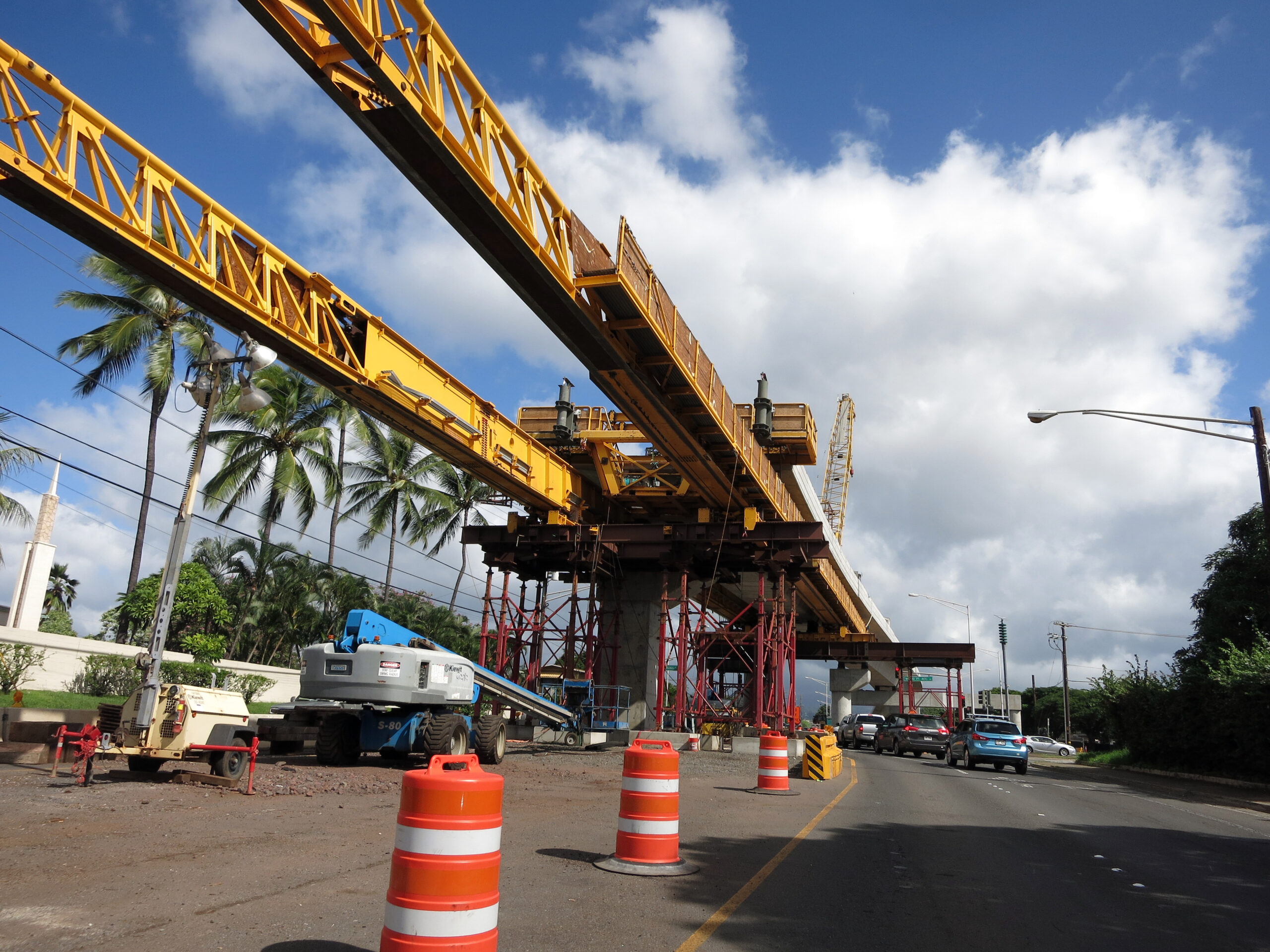 Concrete guideway under construction in road center with machines