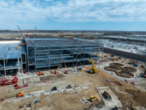 Construction on a Microsoft data center expansion, showing steel framework, cranes, and active development on site.