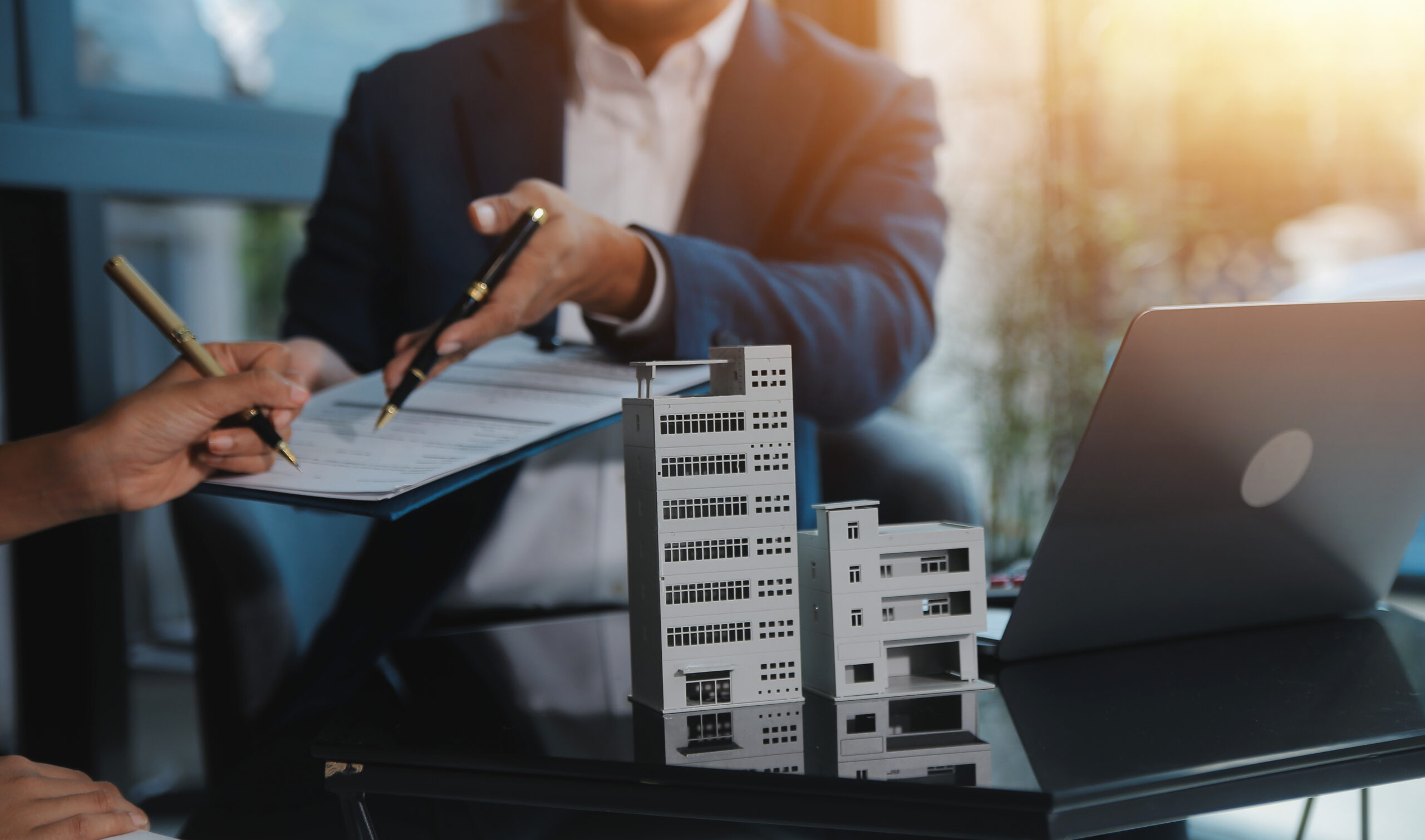 Real estate agent and customer signing contract